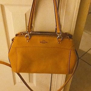 Tan leather coach shoulder/cross strap medium to small in size. 3 compartments